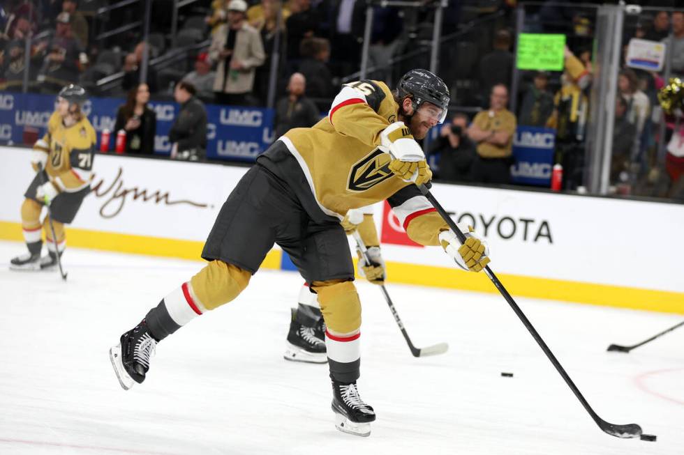 Golden Knights defenseman Noah Hanifin (15) shoots during warmups before an NHL hockey game at ...