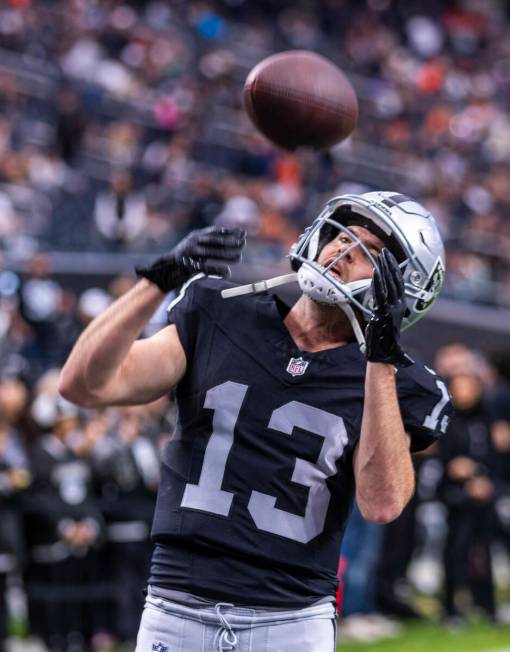 Raiders wide receiver Hunter Renfrow (13) catches a pass warming up against the Denver Broncos ...