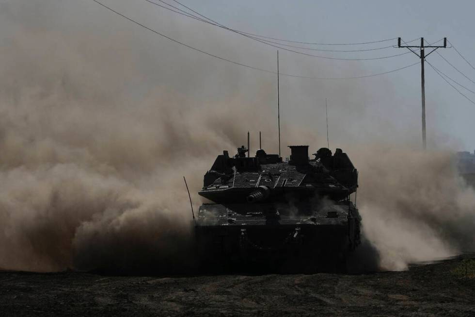 An Israeli tank moves near the Gaza Strip border in southern Israel, Wednesday, March 13, 2024. ...