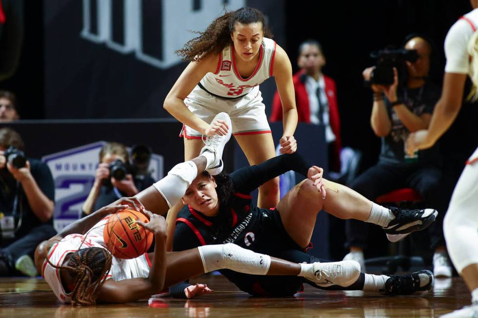 UNLV Lady Rebels center Desi-Rae Young, left, struggles for the ball against San Diego State Az ...