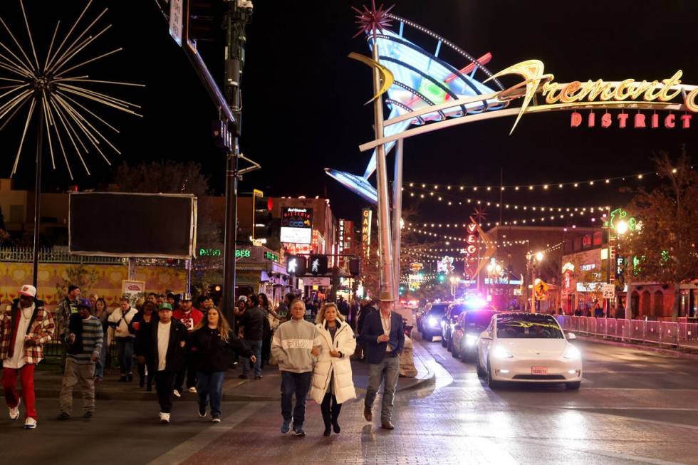 New Year’s Eve revelers make their way across Las Vegas Boulevard to the Time of Your Li ...