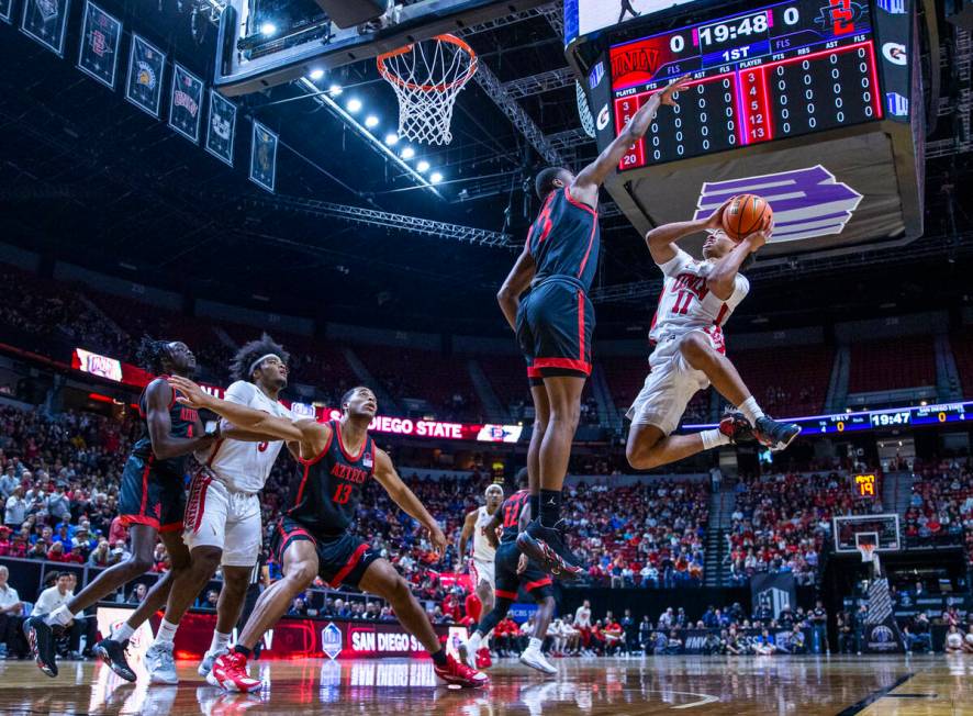 UNLV Rebels guard Dedan Thomas Jr. (11) looks to shoot past San Diego State Aztecs guard Micah ...