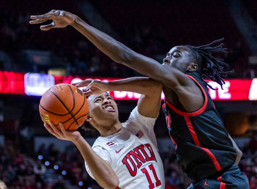 UNLV Rebels guard Dedan Thomas Jr. (11) looks to shoot against San Diego State Aztecs forward J ...