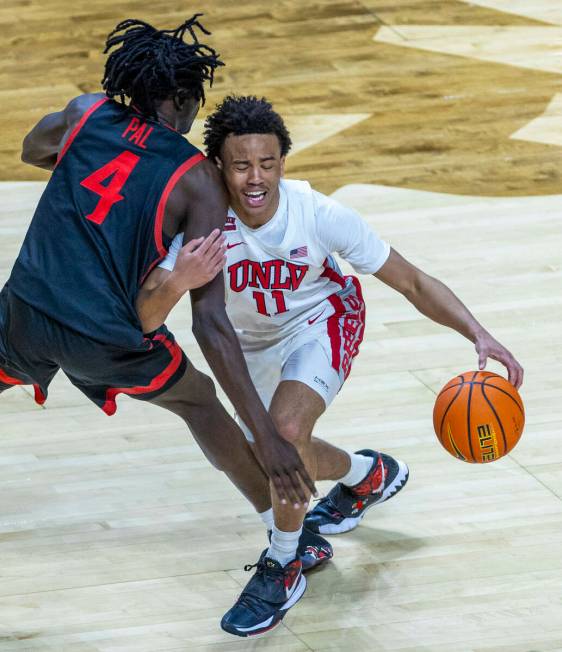 UNLV Rebels guard Dedan Thomas Jr. (11) collides with San Diego State Aztecs forward Jay Pal (4 ...