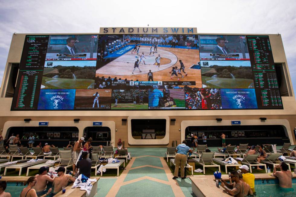 People watch as North Carolina takes on St Peter's in the Elite 8 round of the NCAA tournament ...