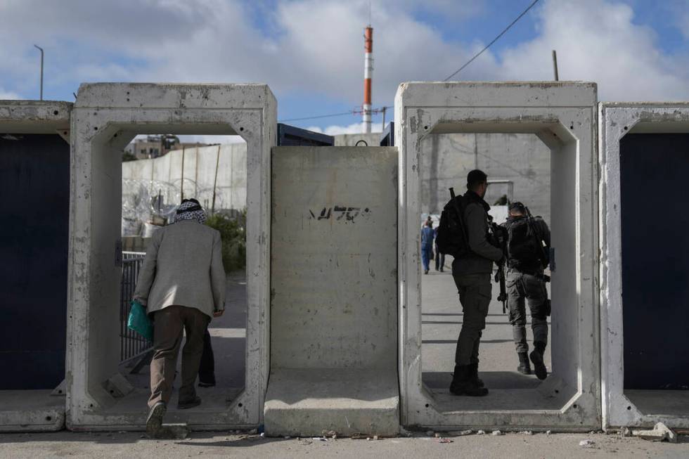 Palestinians cross from the Israeli military Qalandia checkpoint near the West Bank city of Ram ...