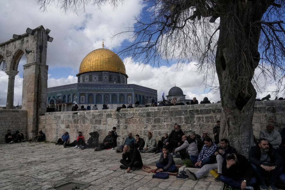 Muslim worshippers gather for Friday prayers by the Dome of Rock at the Al-Aqsa Mosque compound ...