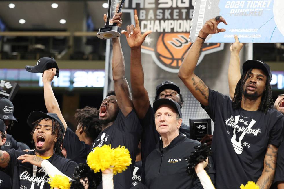 Long Beach State players and head coach Dan Monso, front right, celebrate after an NCAA college ...