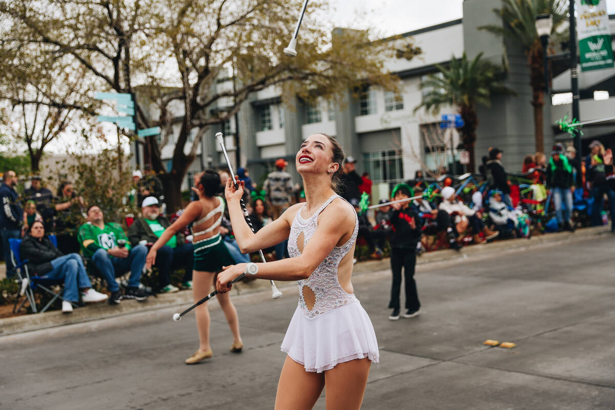 A majorette twirls her batons during the St. Patrick’s Day parade on Water Street on Sat ...
