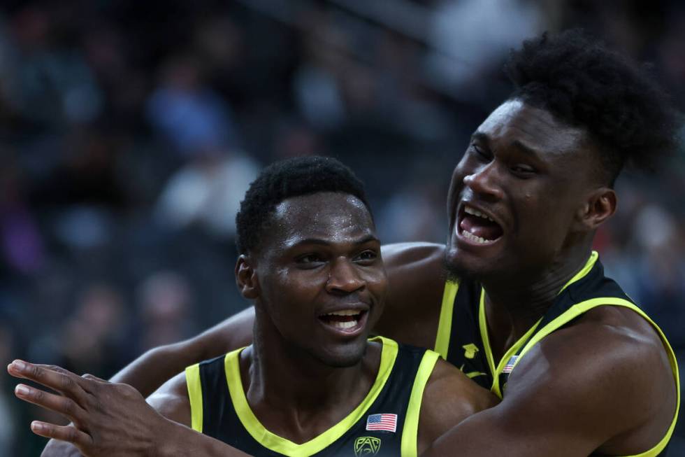 Oregon Ducks forward Mahamadou Diawara, right, embraces center N'Faly Dante as they win the cha ...