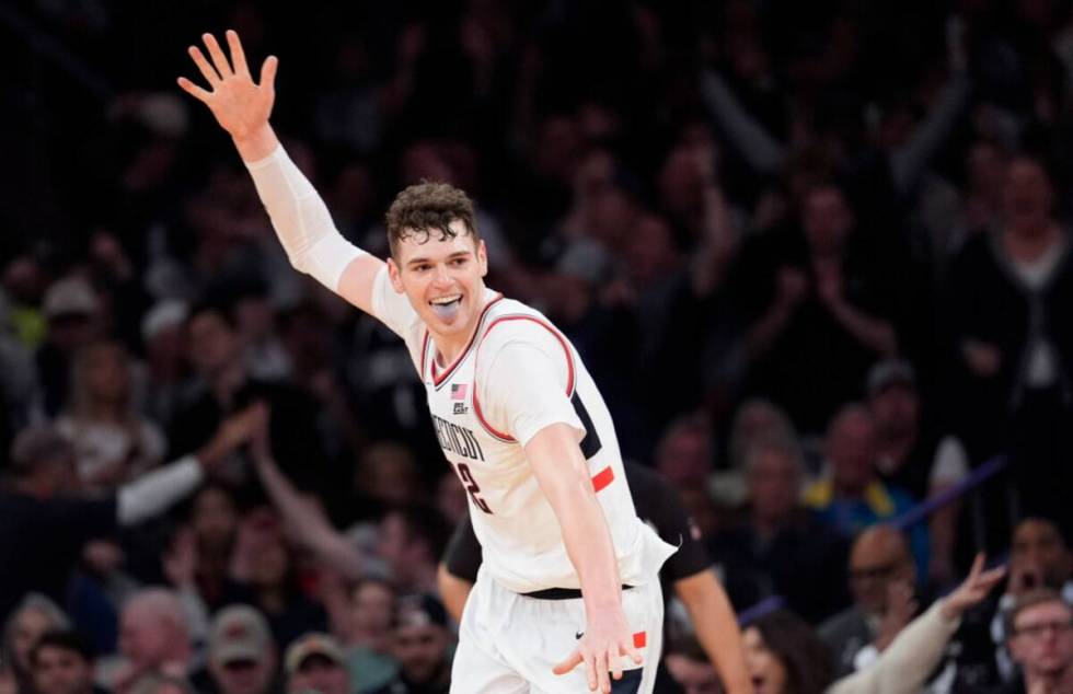 UConn center Donovan Clingan reacts after dunking during the second half of an NCAA college bas ...