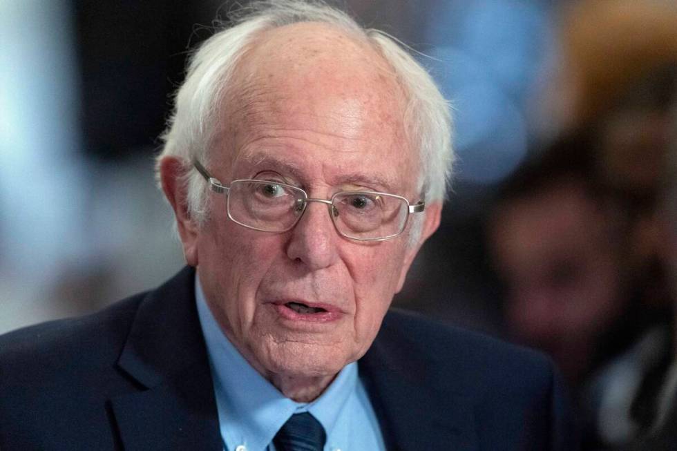 Sen. Bernie Sanders, I-Vt., talks to the media as he walks to the House chamber before Presiden ...