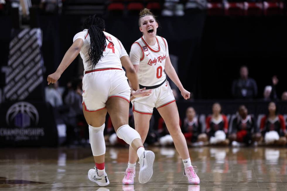 UNLV Lady Rebels forward Alyssa Brown (44) and guard Ashley Scoggin (0) celebrate a score durin ...