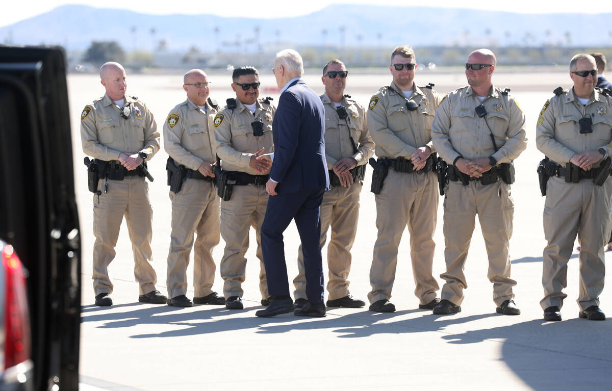 President Joe Biden greets Las Vegas police officers as he arrives back at Harry Reid Internati ...