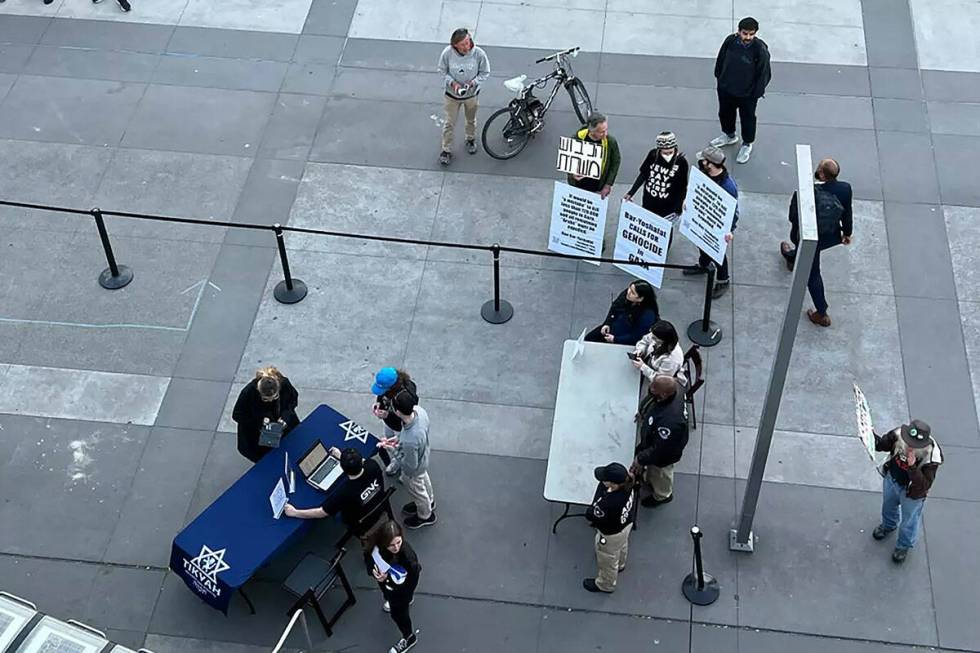 A few protesters gather outside the Pauley Ballroom at UC Berkeley on Monday night, a stark dif ...