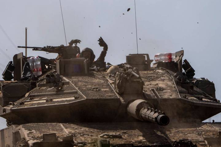 Israeli soldiers drive a tank on the border with Gaza Strip, in southern Israel, Tuesday, March ...