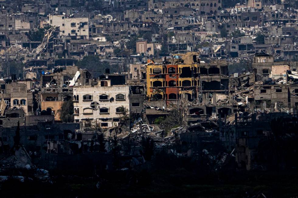 Destroyed buildings stand inside the Gaza Strip, as seen from southern Israel, Tuesday, March 1 ...