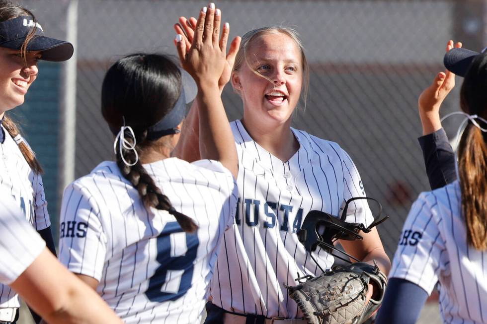 Shadow Ridge pitcher Josslin Law (4) gets a high-five from her teammate Jimena Barraza (8) afte ...