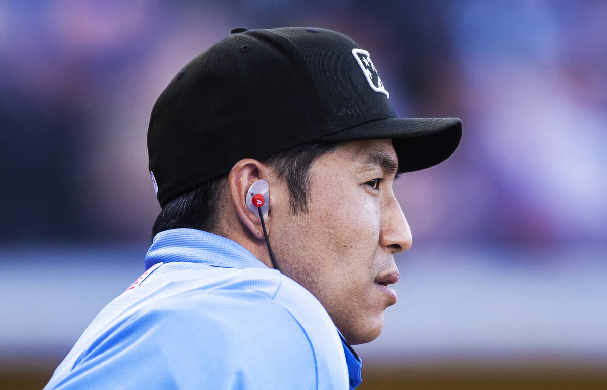 Home plate umpire Takahito Matsuda wears the ear piece connected to the Automated Ball-Strike s ...