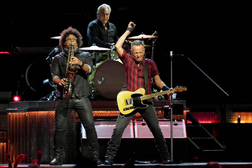 Bruce Springsteen, right, plays his guitar as Jake Clemons, left, plays saxophone as Max Weinbe ...