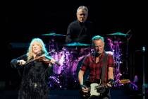 Bruce Springsteen, right, plays his guitar as Max Weinberg, top, plays the drums during a conce ...