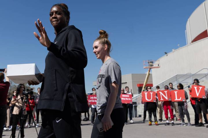 UNLV Lady Rebels center Desi-Rae Young, left, and guard Ashley Scoggin board a bus to Los Angel ...