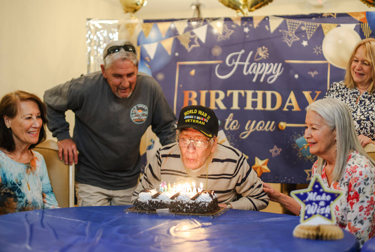 Roy Hashimura, a WW2 veteran, blows out candles on a cake for his 105th birthday surrounded by ...