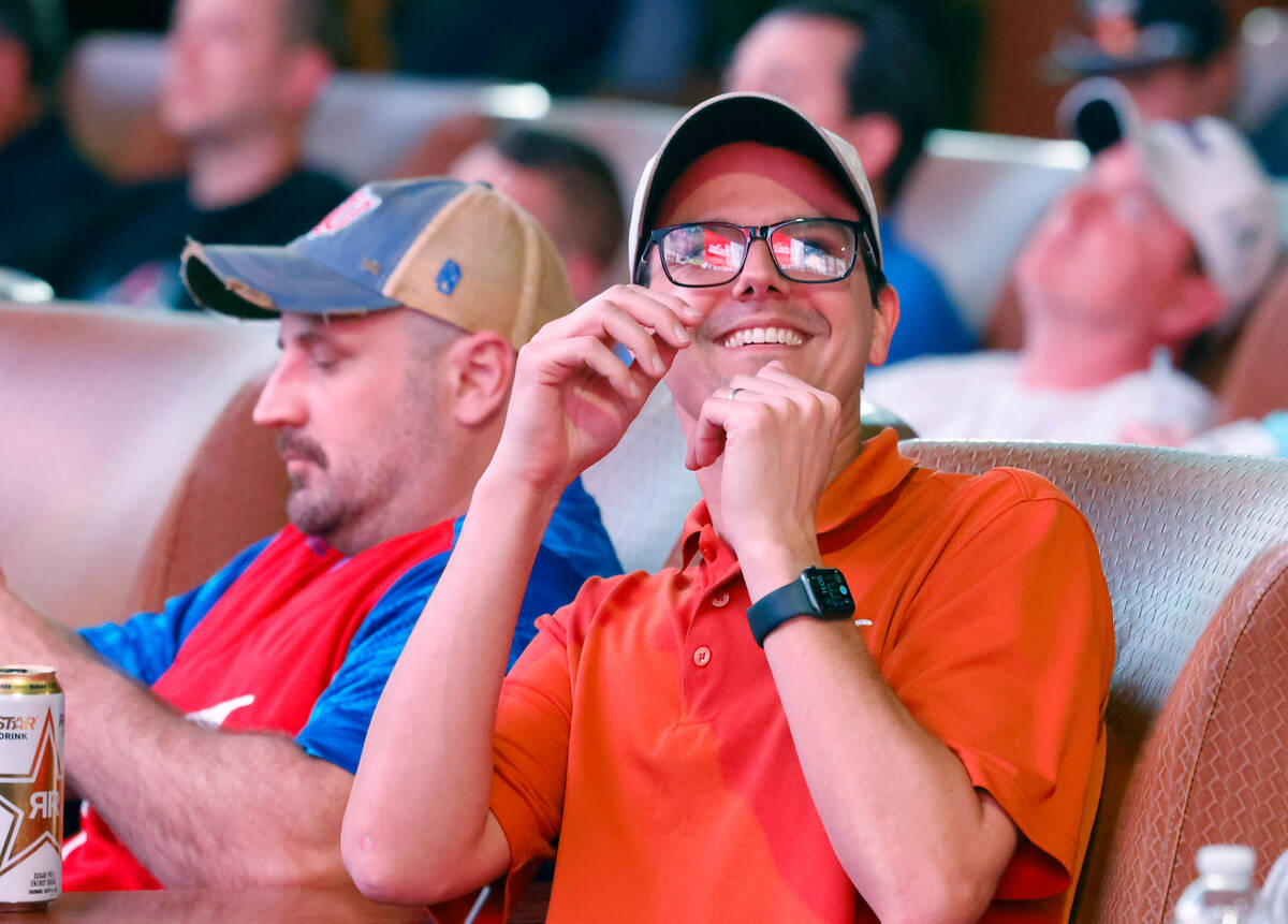 Gus Hodcrofter of Texas reacts to a play as he watches on the big screens the first day of the ...