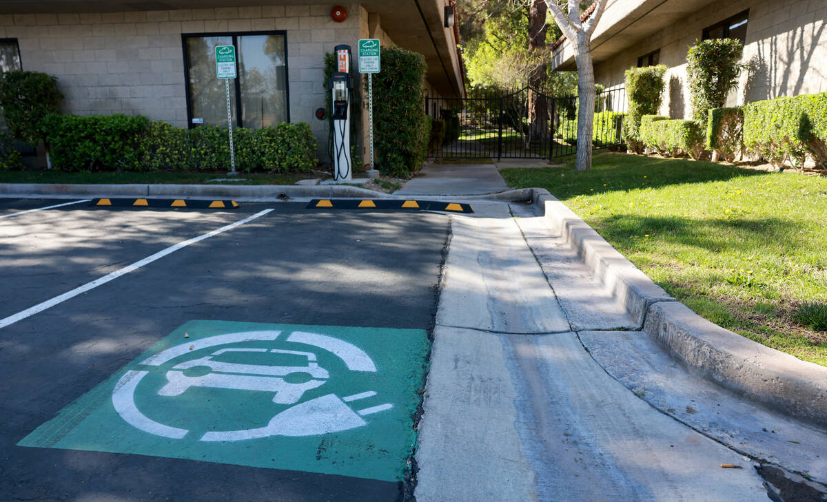 An electric vehicle charging station is shown at an office complex at Rancho and Alta drives in ...