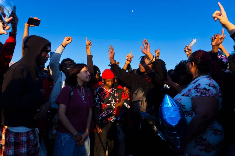 Friends and family react during a vigil in memory of Devin Heath, 17, who died after being hit ...