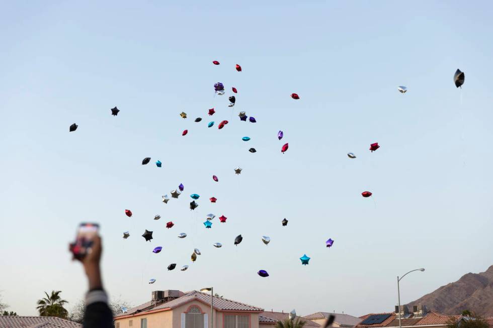 Balloons are released during a vigil in memory of Devin Heath, who died after being hit by a sp ...