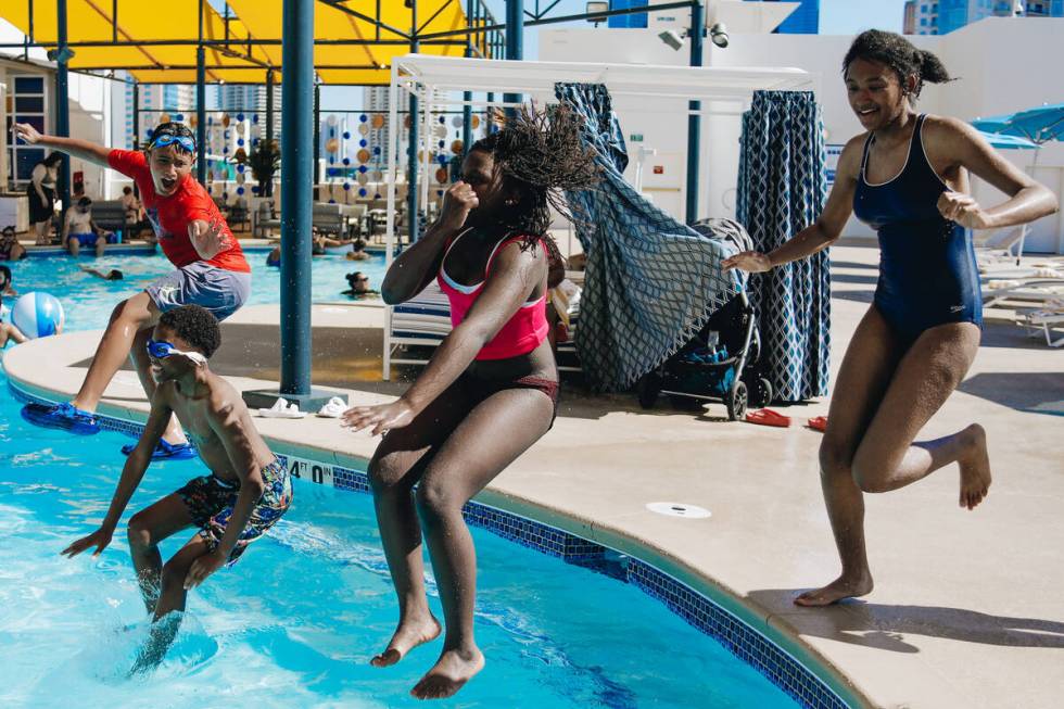 A group of children jump into the pool together on Friday, June 30, 2023, at the Swim and Socia ...