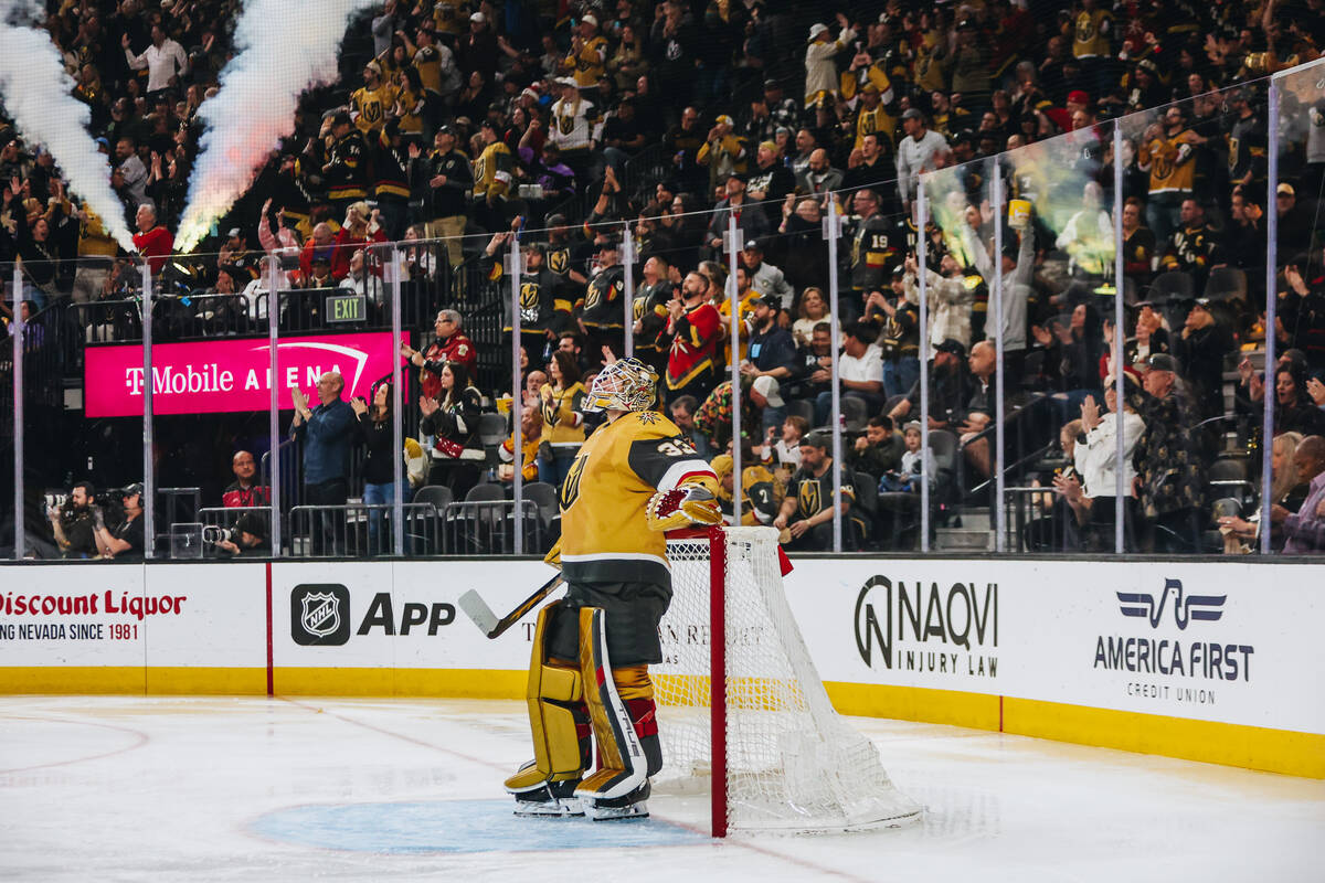 Golden Knights goaltender Adin Hill (33) watches a replay on the screen as fans celebrate a Gol ...