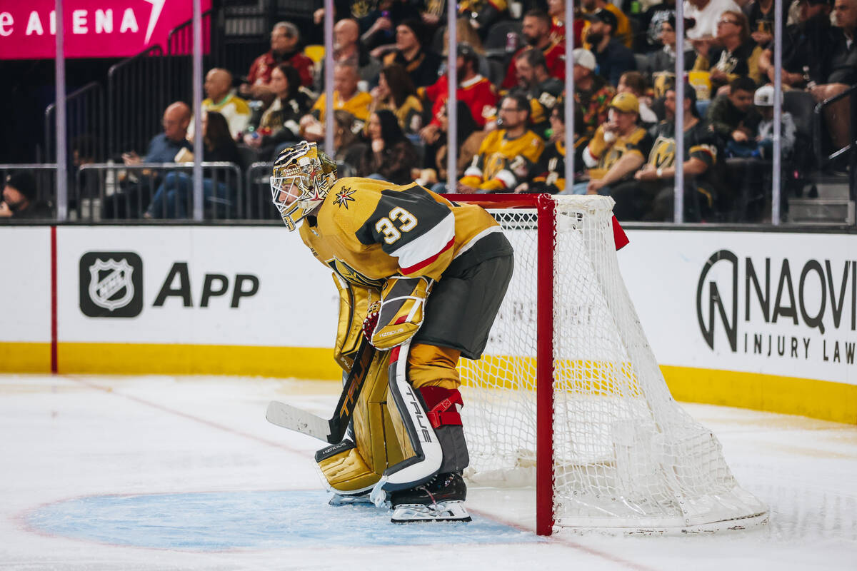 Golden Knights goaltender Adin Hill (33) waits for the action to close in during an NHL hockey ...