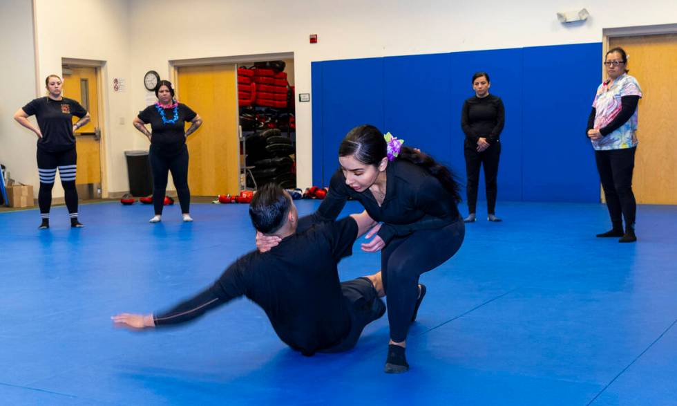 Officer Gina Castaneda Mendoza demonstrates a sweep takedown maneuver on parter Alfredo Lara-Ma ...