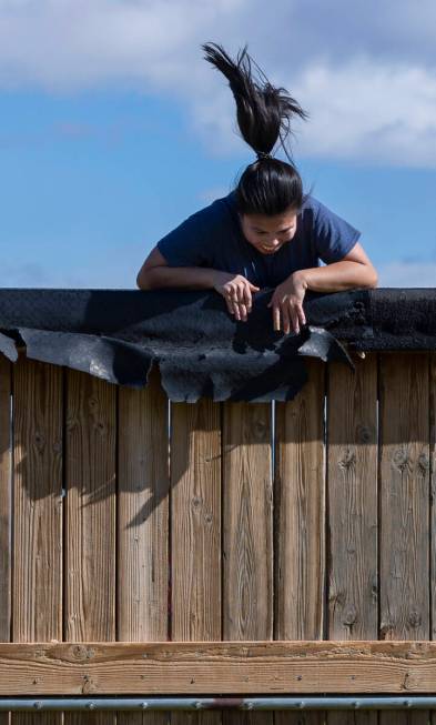 Attendee Melanie Aquino battles to get over a wooden wall as women participate in an outside ci ...