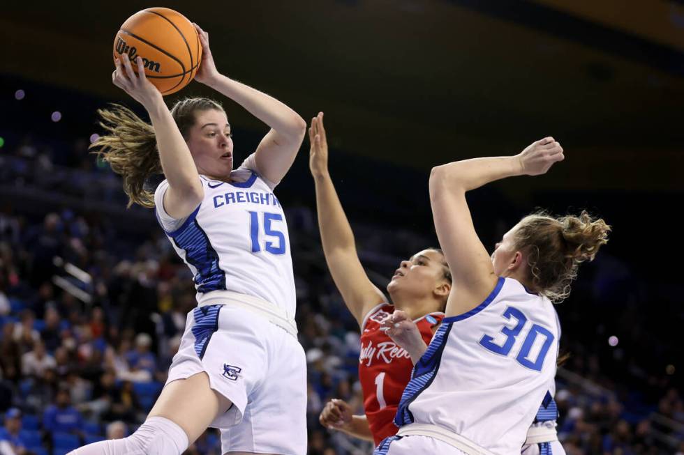 Creighton Bluejays guard Lauren Jensen (15) snags a rebound over UNLV Lady Rebels forward Nneka ...