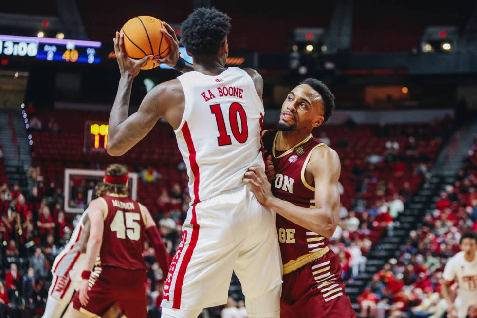UNLV forward Kalib Boone (10) looks to pass the ball to a teammate as a Boston College defender ...