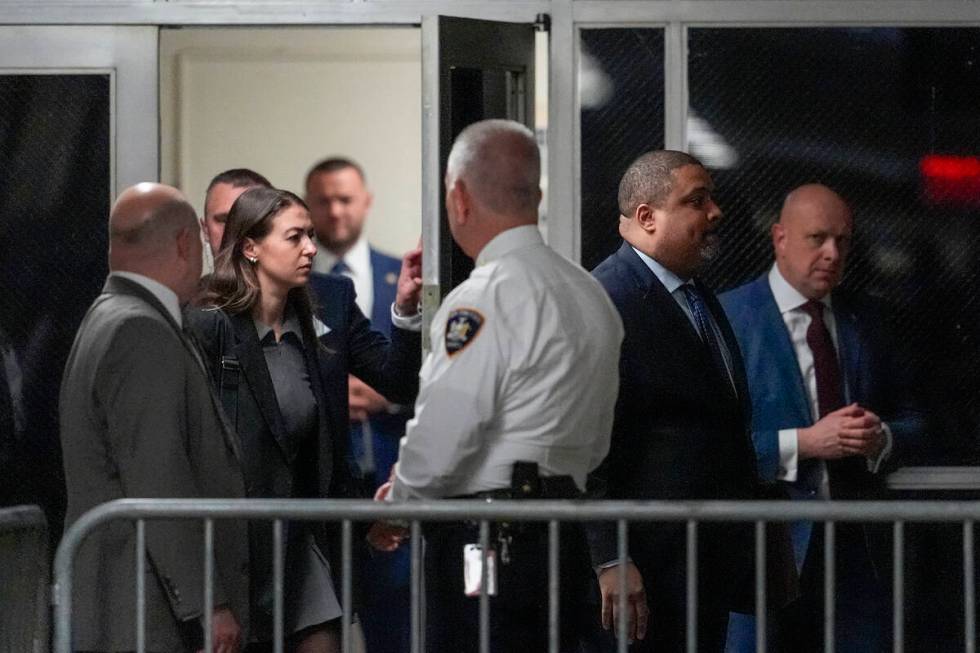 Manhattan district attorney Alvin Bragg, second from right, arrives at Manhattan criminal court ...