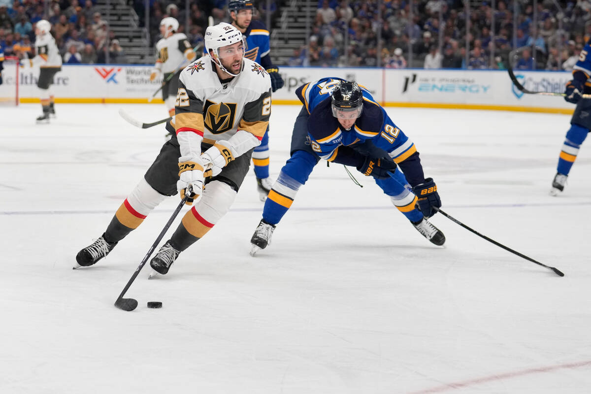 Vegas Golden Knights' Michael Amadio (22) controls the puck as St. Louis Blues' Kevin Hayes (12 ...