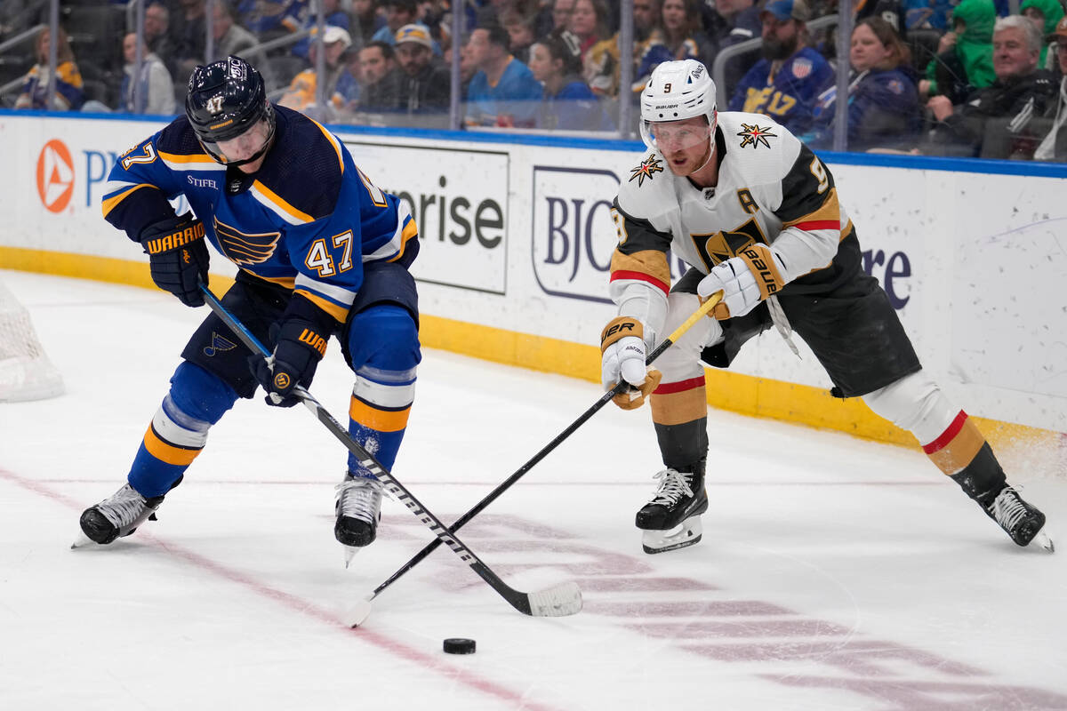 St. Louis Blues' Torey Krug and Vegas Golden Knights' Jack Eichel (9) chase after a loose puck ...