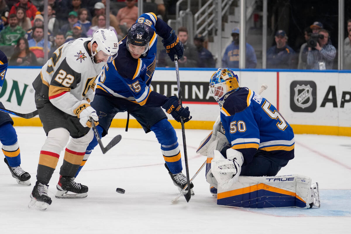 Vegas Golden Knights' Michael Amadio (22) and St. Louis Blues' Colton Parayko (55) battle for a ...