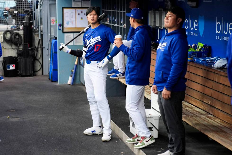 Los Angeles Dodgers designated hitter Shohei Ohtani (17) and relief pitcher Yoshinobu Yamamoto, ...