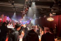 Guests mingle at the Las Vegas Super Bowl Host Committee media party at the Formula One Las Veg ...