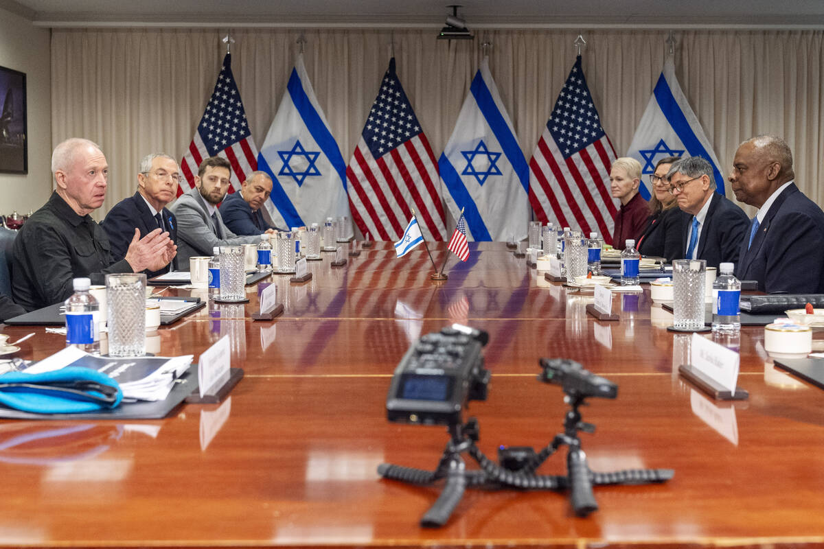 Israeli Defense Minister Yoav Gallant, far left, speaks while meeting with Defense Secretary Ll ...