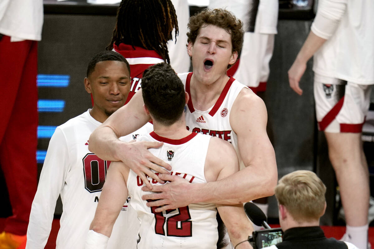 North Carolina State's Ben Middlebrooks, top center, celebrates with Michael O'Connell (12) aft ...