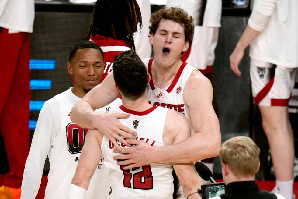 North Carolina State's Ben Middlebrooks, top center, celebrates with Michael O'Connell (12) aft ...