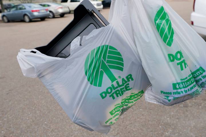 A customer exits a Dollar Tree store holding a shopping bag on Wednesday, May 11, 2022, in Jack ...