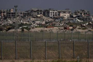 Destroyed buildings stand in the Gaza Strip as seen from southern Israel, Thursday, March 28, 2 ...
