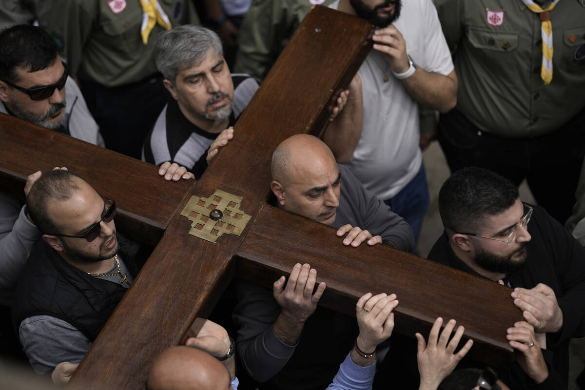 Christians walk the Way of the Cross procession that commemorates Jesus Christ's crucifixion on ...